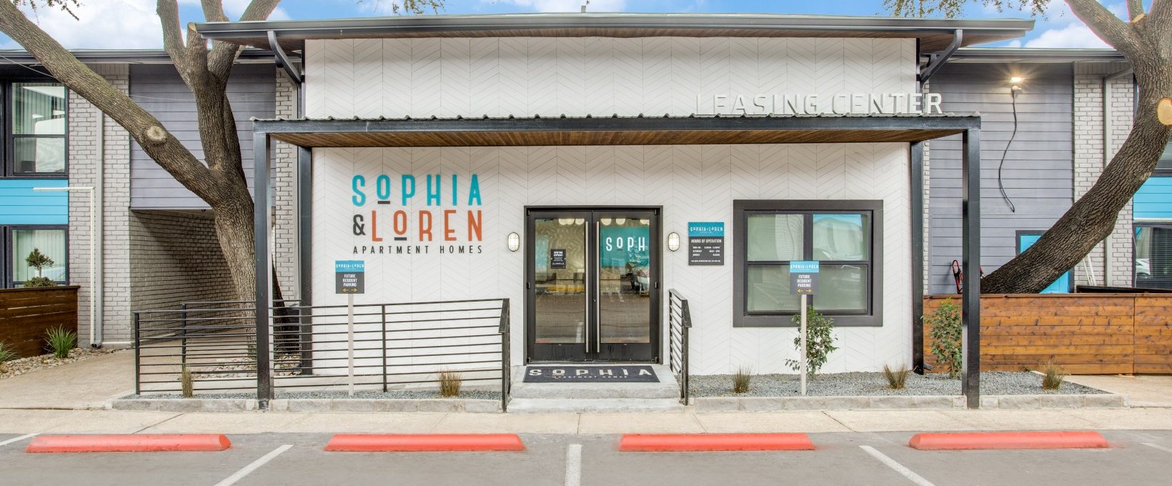 the front entrance to a building with a parking lot at The  Sophia