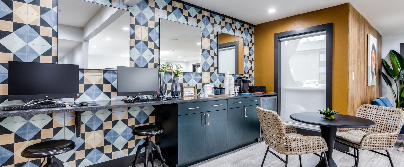 a kitchen with a blue and yellow tile pattern at The  Sophia