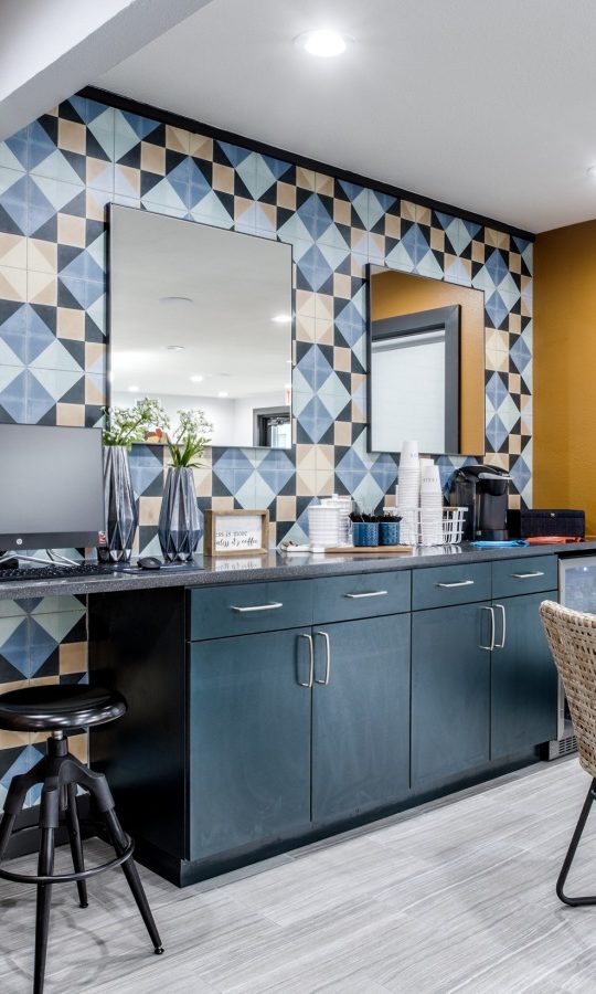 a kitchen with a blue and yellow tile pattern at The  Sophia